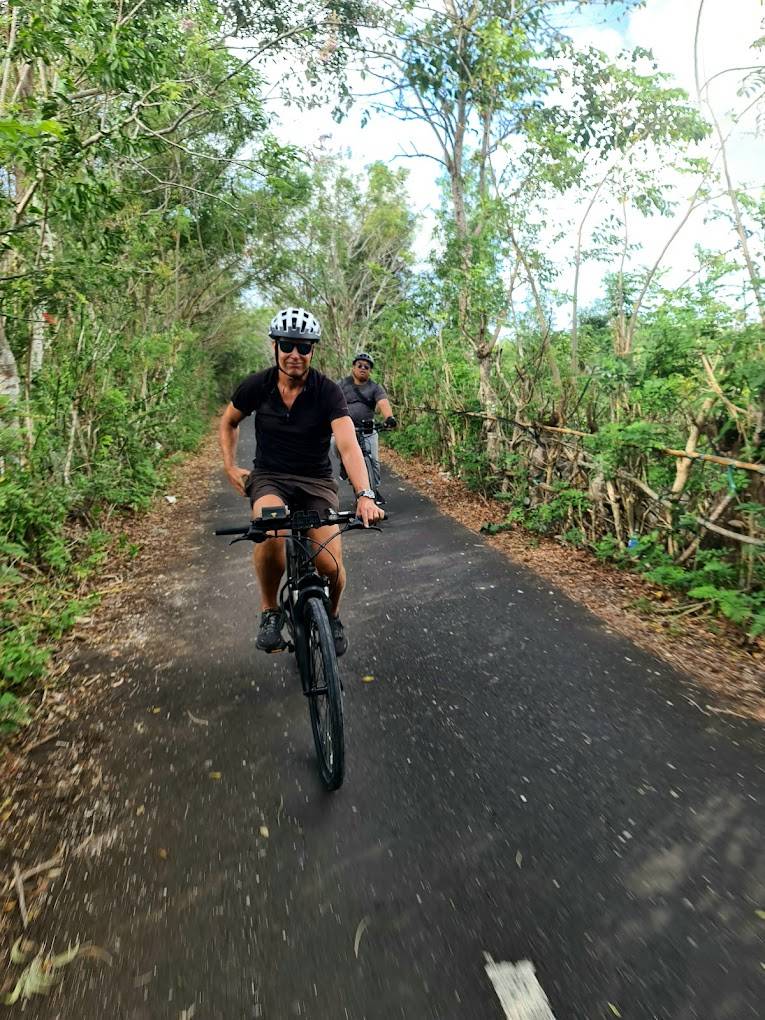Guest enjoying a self-paced e-bike ride through Bali nature trails — UNIKAT rental service