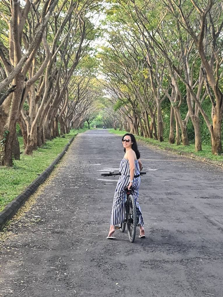 Riders on a scenic tree-lined road in Bali