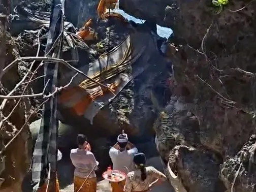 Sacred cliff shrine at Pura Geger with ceremonial offerings